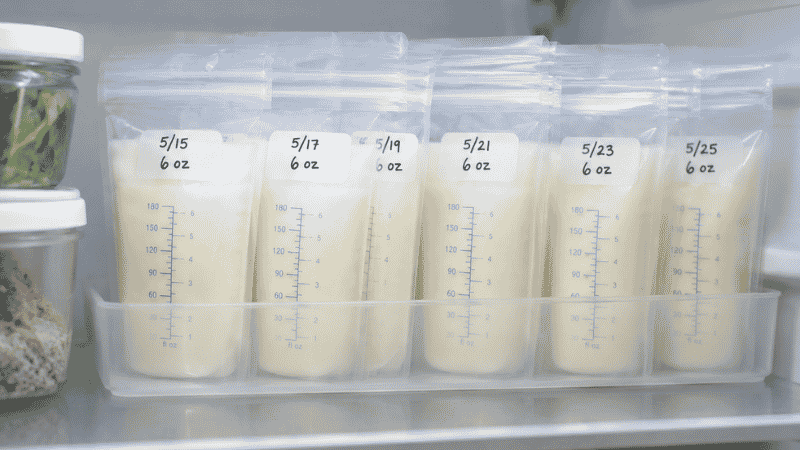 Breast milk storage bags stored neatly at the back of a refrigerator shelf