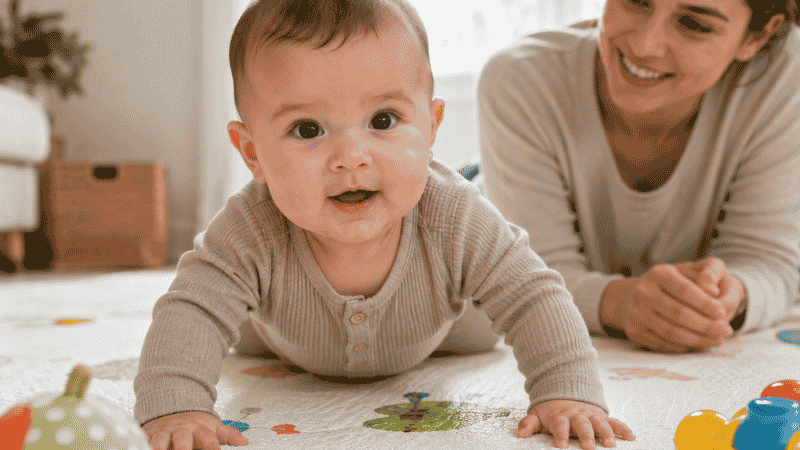 A baby doing tummy time and pushing up on their arms, building the core and neck strength needed to sit up